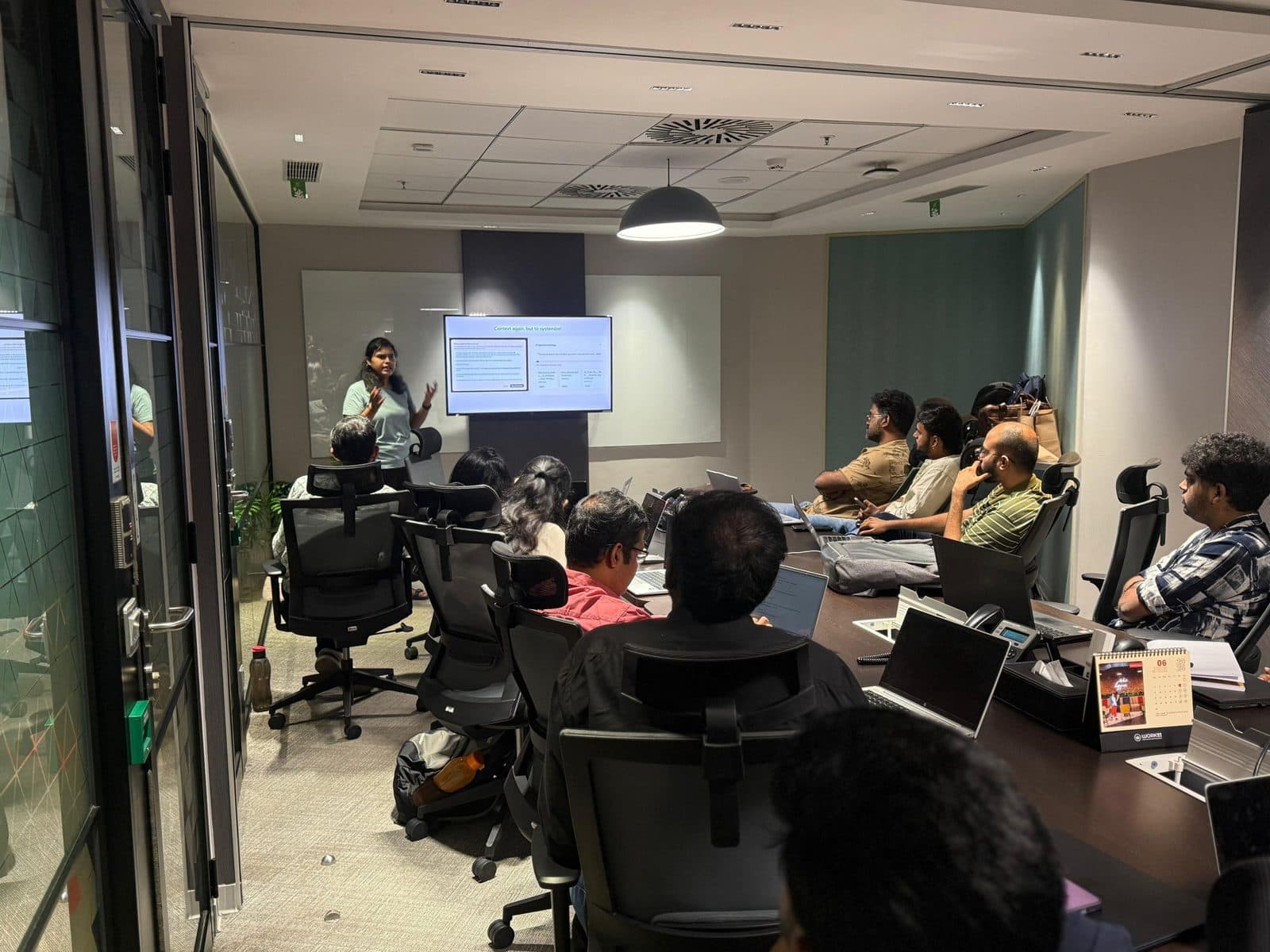 Aishwarya running an agentic-systems workshop for a team in a meeting room